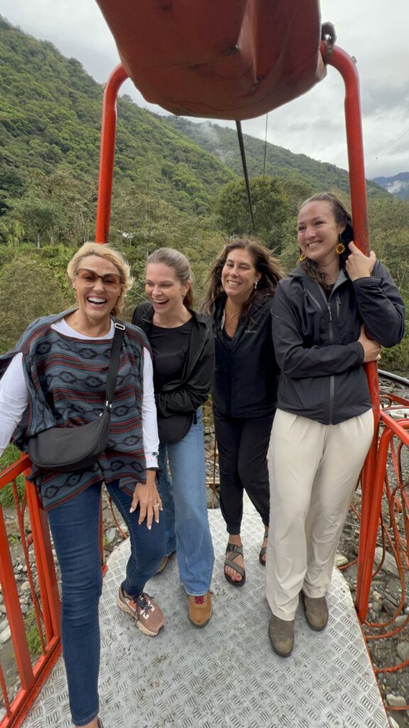 Travelers riding a cable car across a canyon.
