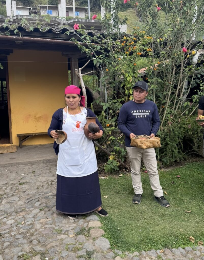 Tour Guide at Kawsaymi Cultural Lunch showing the group hand made bowls used for cooking and eating in their culture.