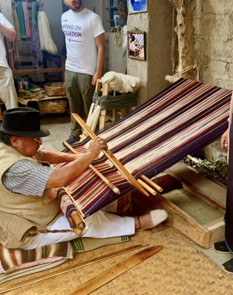 A man weaving at the Tahuantinsuyo Weaving Workshop